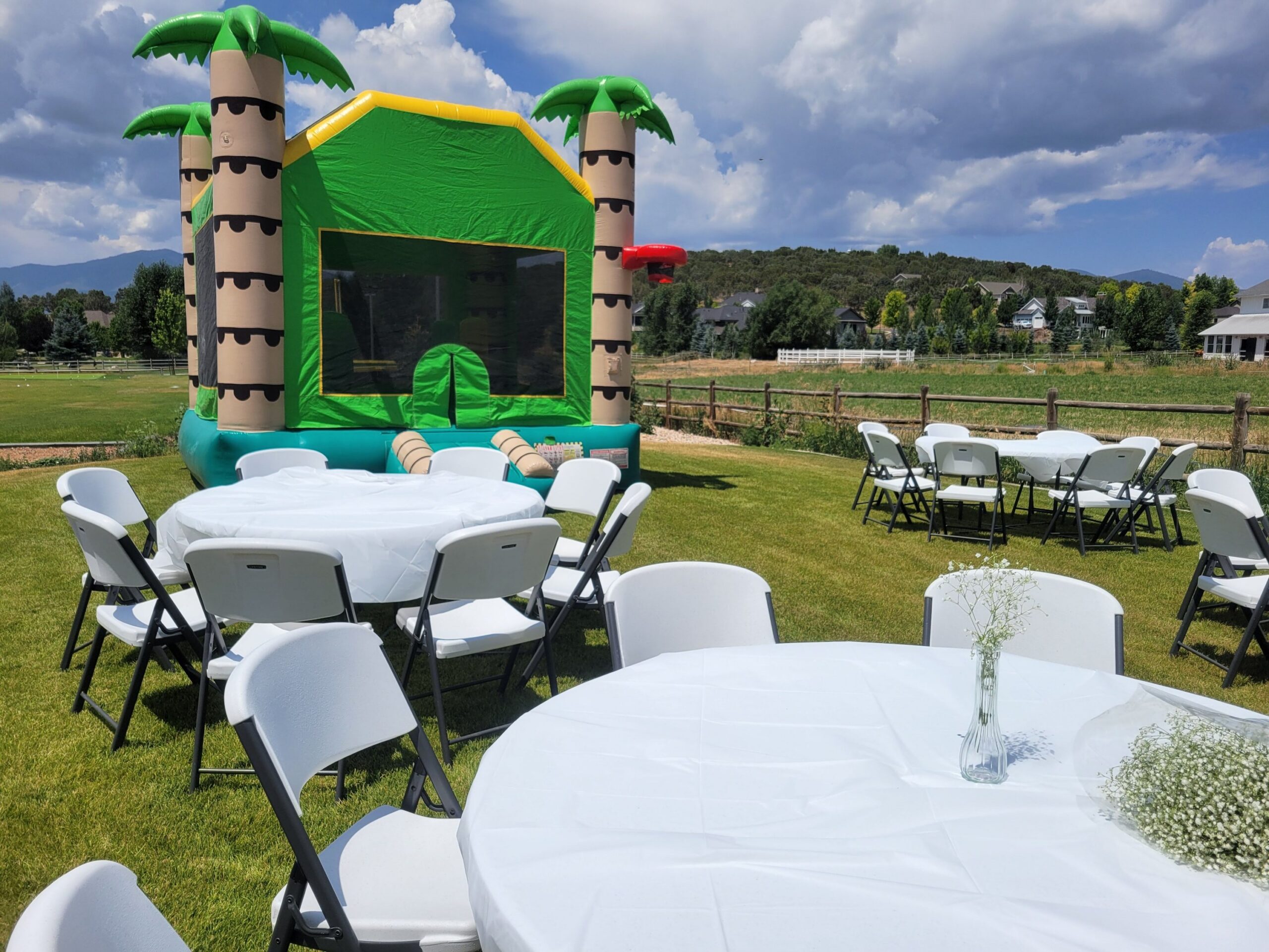Bounce house set up with tables and chairs